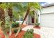 Inviting front entrance with a brick walkway, lush greenery, and a vibrant red front door at 2334 50Th Street E Cir, Palmetto, FL 34221
