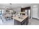 Open-concept kitchen with stainless steel appliances and island flows into the dining and living areas at 2334 50Th Street E Cir, Palmetto, FL 34221