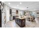 Open kitchen with a central island, dark wood cabinetry, granite countertops, and stainless steel appliances at 2334 50Th Street E Cir, Palmetto, FL 34221