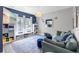 Bright living room with a plush sofa, matching ottomans, large windows, and custom shelving at 2334 50Th Street E Cir, Palmetto, FL 34221
