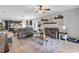 Open-concept living room with cozy seating, stylish decor, and connection to the kitchen and dining area at 2334 50Th Street E Cir, Palmetto, FL 34221