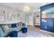 Cozy living room with a comfortable blue sofa, plush ottomans, and charming decor throughout at 2334 50Th Street E Cir, Palmetto, FL 34221