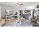 Bright and airy living room with beachy art, backyard views, and comfortable furniture at 2334 50Th Street E Cir, Palmetto, FL 34221