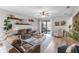 Comfortable living room with a ceiling fan, sliding glass doors, and neutral decor at 2334 50Th Street E Cir, Palmetto, FL 34221