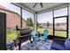 Relaxing screened-in patio with grill, water view, and comfortable seating at 2334 50Th Street E Cir, Palmetto, FL 34221
