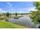 Scenic pond view surrounded by manicured lawns and beautiful landscaping at 2334 50Th Street E Cir, Palmetto, FL 34221