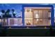 Modern residence featuring clean lines, a cascading water feature, a private pool, and lush tropical landscaping at 2470 Ringling Blvd, Sarasota, FL 34237