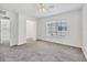 Bedroom featuring neutral carpet, a ceiling fan, and a large window at 262 Cape Harbour Loop # 101, Bradenton, FL 34212