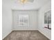 Bedroom with carpeting, ceiling fan, and large window at 262 Cape Harbour Loop # 101, Bradenton, FL 34212