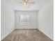Bedroom featuring neutral carpet, a ceiling fan, and a large window at 262 Cape Harbour Loop # 101, Bradenton, FL 34212