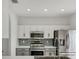 Modern kitchen featuring stainless steel appliances, light countertops, and sleek gray and white cabinets at 262 Cape Harbour Loop # 101, Bradenton, FL 34212