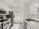 Modern kitchen featuring stainless steel appliances, light countertops, and sleek gray and white cabinets at 262 Cape Harbour Loop # 101, Bradenton, FL 34212