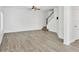 Bright living room with ceiling fan, wood-look flooring, and staircase access at 262 Cape Harbour Loop # 101, Bradenton, FL 34212