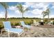 Inviting backyard features a paved area with lounge chairs and a fire pit, perfect for outdoor gatherings at 26687 Raphis Royale Blvd, Englewood, FL 34223