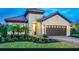 Charming single-story home with a well-manicured lawn and a two-car garage at 26687 Raphis Royale Blvd, Englewood, FL 34223