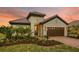 Charming single-Gathering home with a tile roof, two-car garage, and beautifully landscaped front yard at 26687 Raphis Royale Blvd, Englewood, FL 34223