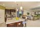 Modern kitchen with stainless steel appliances and a breakfast bar with seating at 26687 Raphis Royale Blvd, Englewood, FL 34223
