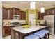 Modern kitchen with stainless steel appliances and a breakfast bar with seating at 26687 Raphis Royale Blvd, Englewood, FL 34223