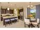 Modern kitchen with stainless steel appliances and a breakfast bar with seating at 26687 Raphis Royale Blvd, Englewood, FL 34223