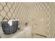 Light and airy laundry room with front loading washer and dryer and patterned wallpaper at 26687 Raphis Royale Blvd, Englewood, FL 34223