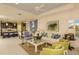 Bright living room with a white sofa, decorative pillows, and large windows at 26687 Raphis Royale Blvd, Englewood, FL 34223
