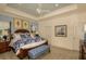 Bright bedroom features tray ceiling, a ceiling fan, plantation shutters, and an ensuite bathroom at 26687 Raphis Royale Blvd, Englewood, FL 34223