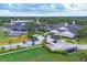 Aerial view showcases the golf course, clubhouse, lush landscaping, and ample parking at 2914 Dick Wilson Dr, Sarasota, FL 34240