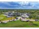 Sprawling golf course community featuring mature trees, manicured landscaping, clubhouse, and cart paths at 2914 Dick Wilson Dr, Sarasota, FL 34240