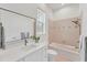 Bathroom featuring white vanity with stone countertop and tiled bath and shower at 2914 Dick Wilson Dr, Sarasota, FL 34240