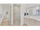 Elegant bathroom with walk-in shower with decorative tile, gray cabinets, and white countertops at 2914 Dick Wilson Dr, Sarasota, FL 34240