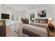A large bedroom with french doors, a ceiling fan, a flat screen tv, and windows for ample light at 2914 Dick Wilson Dr, Sarasota, FL 34240
