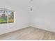 Minimalist bedroom featuring hardwood floors, a ceiling fan, and a window with natural light at 2914 Dick Wilson Dr, Sarasota, FL 34240