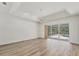 Spacious bedroom featuring hardwood floors and sliding glass doors that open up to the pool area at 2914 Dick Wilson Dr, Sarasota, FL 34240