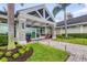 Inviting clubhouse entrance features manicured landscaping, a porte-cochere, and stone accents at 2914 Dick Wilson Dr, Sarasota, FL 34240