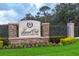 Elegant Laurel Oak Estates & Country Club entrance sign surrounded by lush landscaping and colorful flowers at 2914 Dick Wilson Dr, Sarasota, FL 34240