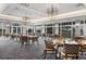 Elegant dining area with modern light fixtures, comfortable seating, and picturesque golf course views at 2914 Dick Wilson Dr, Sarasota, FL 34240