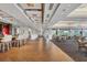 Spacious dining room with hardwood floors, contemporary lighting, full bar and golf course views at 2914 Dick Wilson Dr, Sarasota, FL 34240