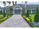 Elegant entrance to Laurel Oak Estates featuring a beautifully landscaped walkway and manicured shrubbery at 2914 Dick Wilson Dr, Sarasota, FL 34240