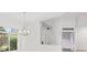 Open-concept entryway featuring a chandelier, transom window, and a glimpse of the interior space at 2914 Dick Wilson Dr, Sarasota, FL 34240