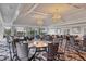 Large event space with chandelier lighting, neutral decor, and tables ready for a special occasion at 2914 Dick Wilson Dr, Sarasota, FL 34240