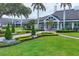 Exterior view of the Laurel Oak Estates clubhouse with well-manicured landscaping and vibrant green lawns at 2914 Dick Wilson Dr, Sarasota, FL 34240