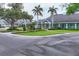 Exterior view of Laurel Oak Estates clubhouse, featuring lush landscaping and elegant architectural details at 2914 Dick Wilson Dr, Sarasota, FL 34240