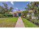 Charming home with a well-maintained lawn, mature landscaping, and a welcoming front entrance at 2914 Dick Wilson Dr, Sarasota, FL 34240
