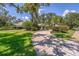 Beautiful home featuring meticulously landscaped front yard with winding driveway and lush greenery at 2914 Dick Wilson Dr, Sarasota, FL 34240
