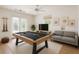 Game room features a pool table, large TV and a comfortable seating area at 2914 Dick Wilson Dr, Sarasota, FL 34240