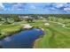 Aerial view of the meticulously landscaped golf course with water feature, sand traps and mature trees at 2914 Dick Wilson Dr, Sarasota, FL 34240