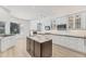 Modern kitchen with an island, white cabinetry, black countertops, and stainless steel appliances at 2914 Dick Wilson Dr, Sarasota, FL 34240