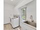 Bright laundry room with appliances, sleek countertops, and ample storage, complemented by natural light at 2914 Dick Wilson Dr, Sarasota, FL 34240