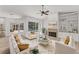 Cozy living room with a fireplace, built-in shelving, and view of the outdoor pool area at 2914 Dick Wilson Dr, Sarasota, FL 34240