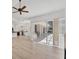Open-concept living room with hardwood floors, flowing into a modern kitchen and featuring access to the patio at 2914 Dick Wilson Dr, Sarasota, FL 34240